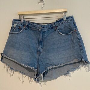 High rise mom shorts in light-medium blue with some distressing